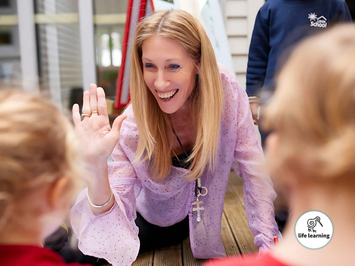 An educator expressing the joy and happiness to her young students making them comfortable and building a good relationship.