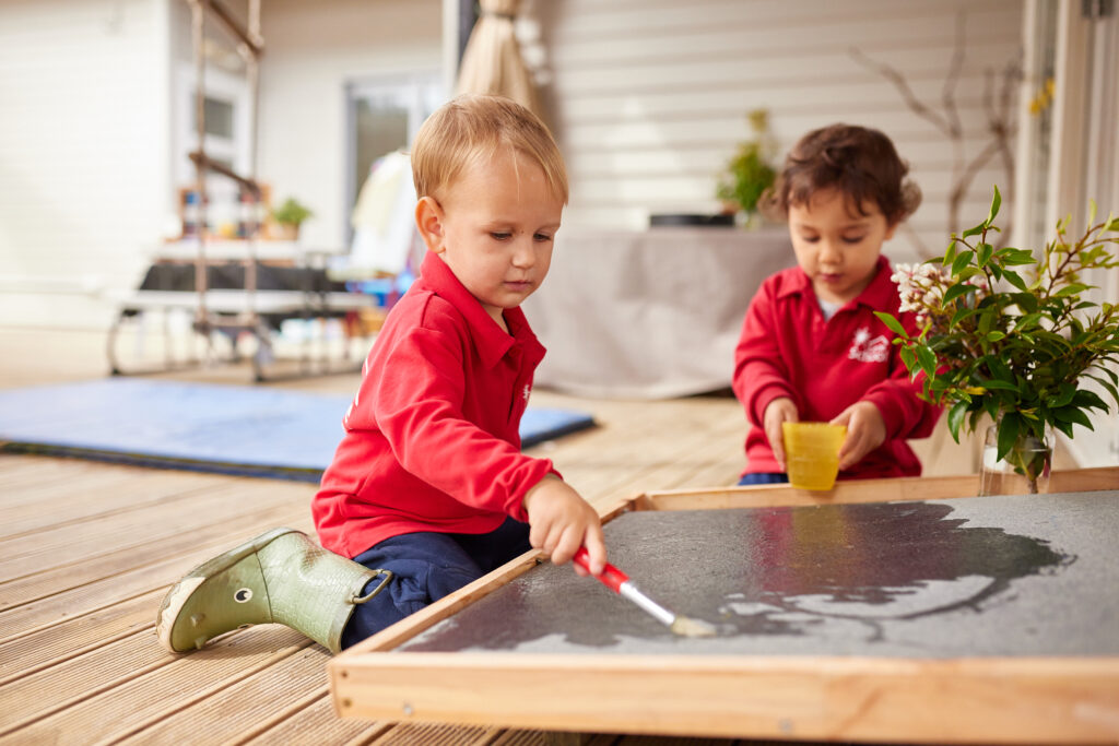 An image of kids painting and exploring their creativity