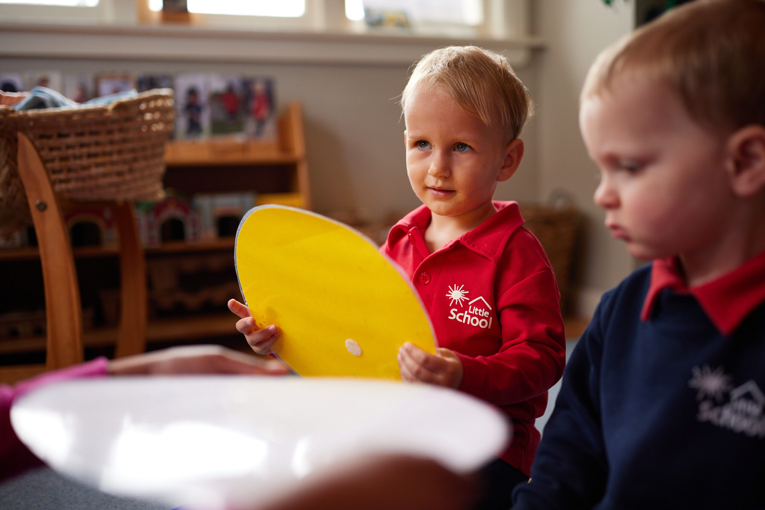 An image of kid focusing on the things teacher taught to them