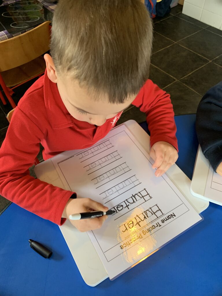 An image of a kid writing and learning