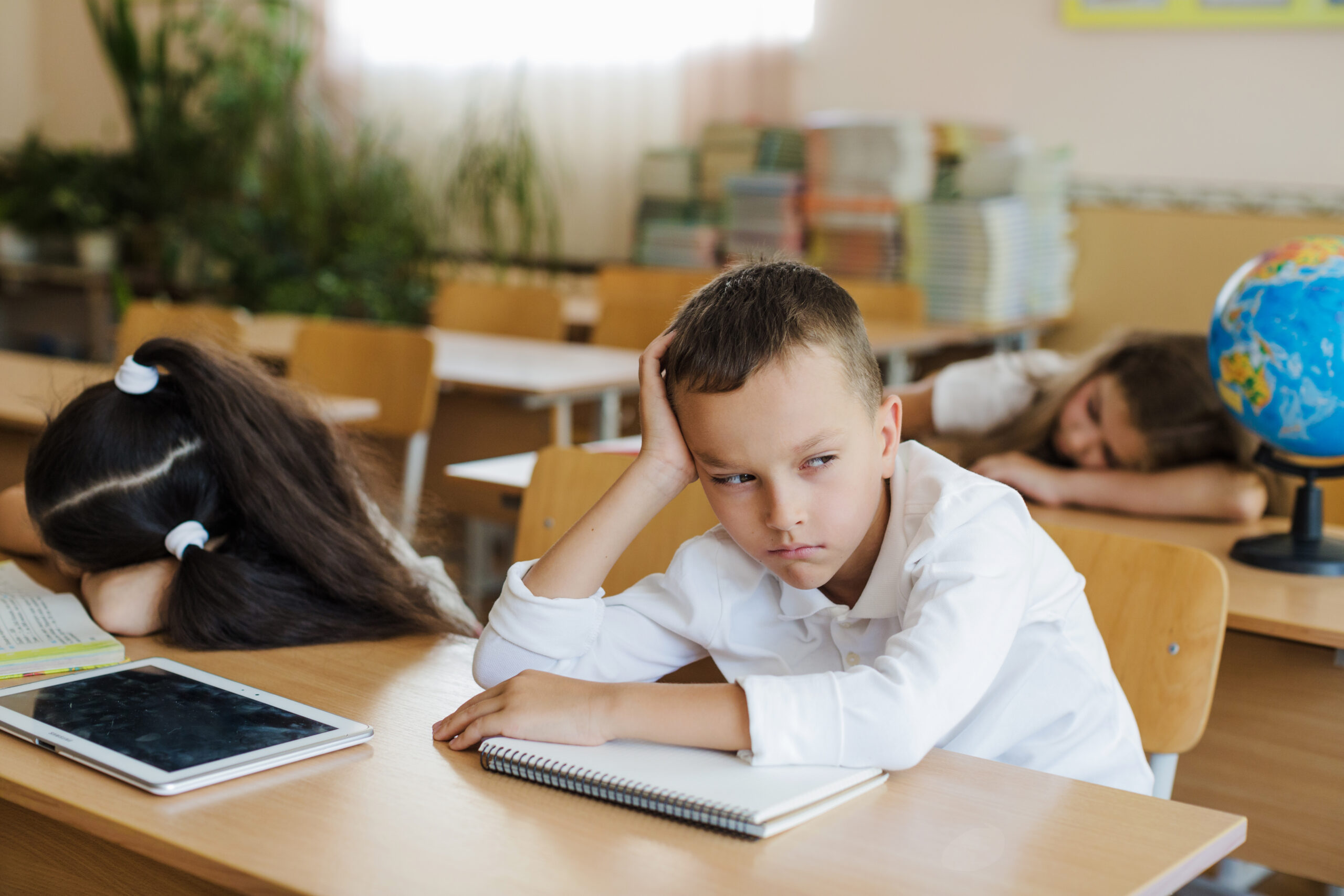 A boy sitting in classroom looking away