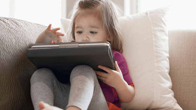 An image of a kid using her ipad