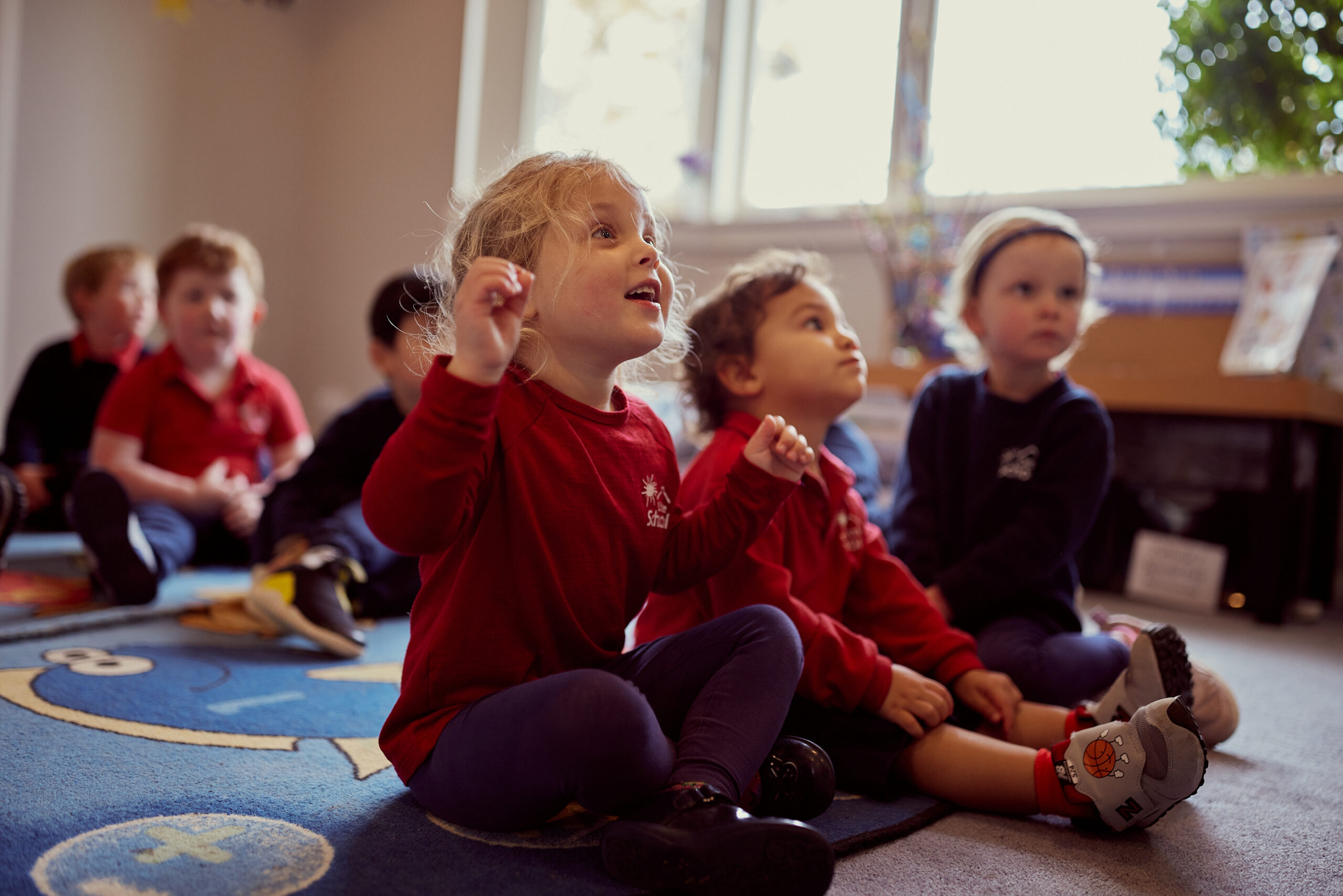 Early childhood educator supporting young children in a learning environment